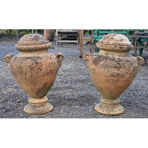 18 - Pair of terracotta twin handled lidded urns, H 60cm x W 47cm (2)