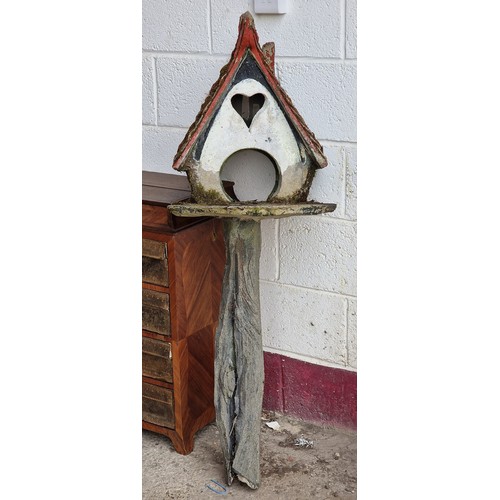 26 - Two naive folk art reconstituted stone dovecots with painted detail, largest H 132cm x W 50cm (2)