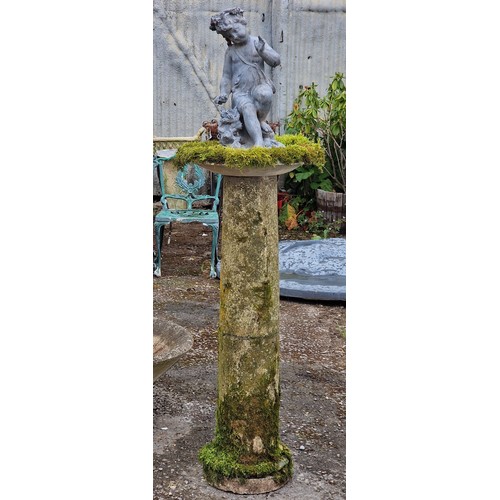 27 - Weathered reconstituted stone birdbath with lead cherub surmount, H 150cm x W 44cm