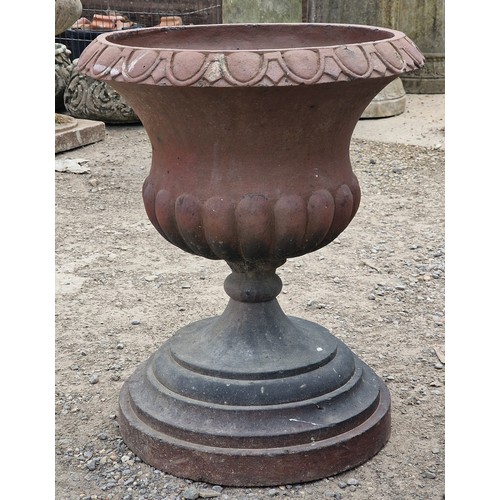 31 - Pair of salt glazed terracotta urns with lobed bowls and flared darted rims, raised on stepped circu... 