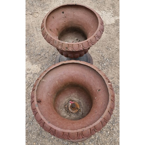31 - Pair of salt glazed terracotta urns with lobed bowls and flared darted rims, raised on stepped circu... 