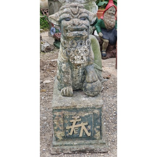 33 - Reconstituted stone statue of a Foo dog raised on a plinth with gilded relief, H 80cm x W 33cm x D 5... 