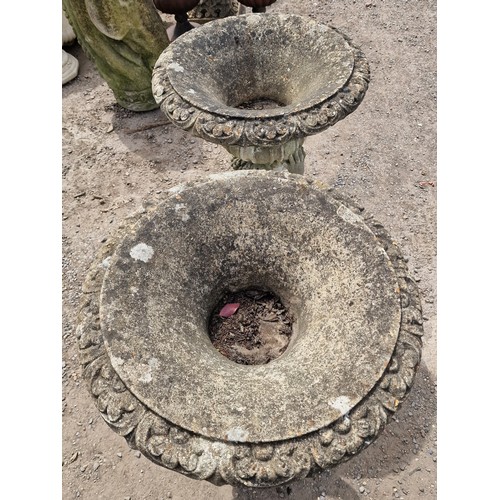 34 - Pair of weathered reconstituted stone garden urns with lobed bowls and foliate swag detail, raised o... 