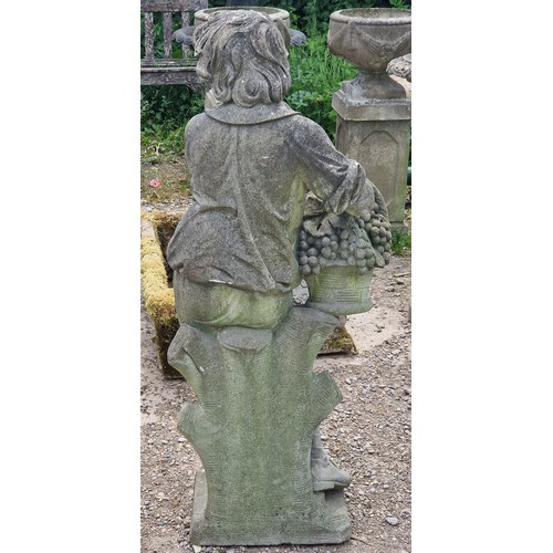 35 - Haddonstone - Weathered reconstituted stone statue of a boy holding a basket of grapes, H 117cm x W ... 