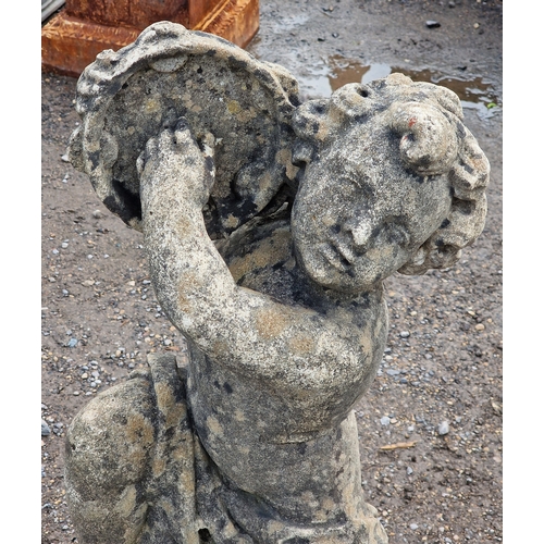 39 - Weathered reconstituted stone garden statue of a musical cherub seated on a ball pier cap playing th... 