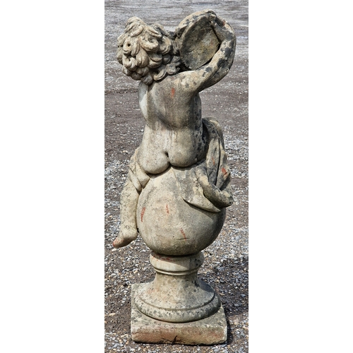 39 - Weathered reconstituted stone garden statue of a musical cherub seated on a ball pier cap playing th... 