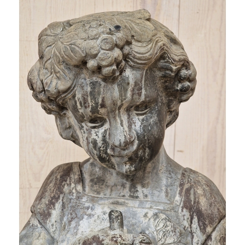 45 - Lead statue of a girl holding a bunch of grapes raised on a weathered reconstituted stone plinth wit... 