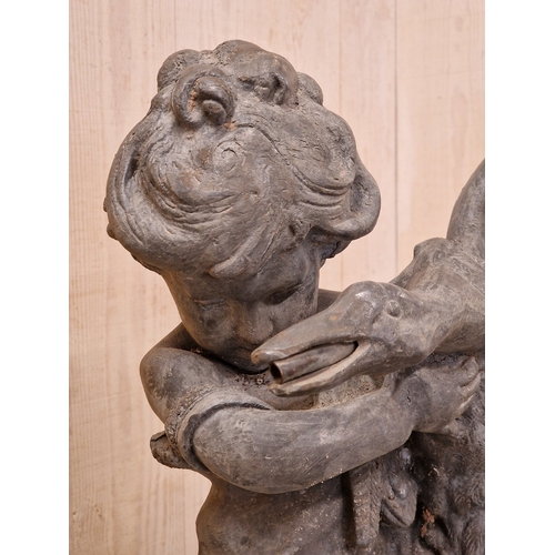 46 - Lead water feature of a boy holding a duck raised on a weathered natural stone domed plinth, H 81cm ... 