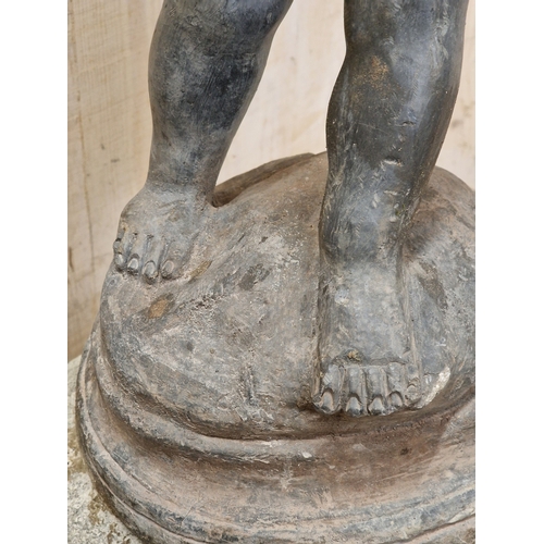 46 - Lead water feature of a boy holding a duck raised on a weathered natural stone domed plinth, H 81cm ... 