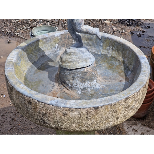52 - Weathered reconstituted stone bird bath with lead lined bowl raised on an octagonal column, surmount... 