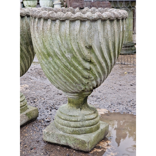 53 - Set of four weathered reconstituted stone garden urns with spiral twist bowls, H 65cm x W 46cm (4)