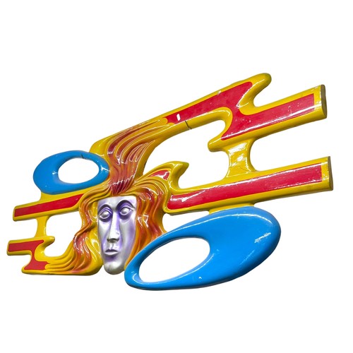 30 - A large fairground painted fibreglass pierced wall panel in the form of a stylised face with flaming... 