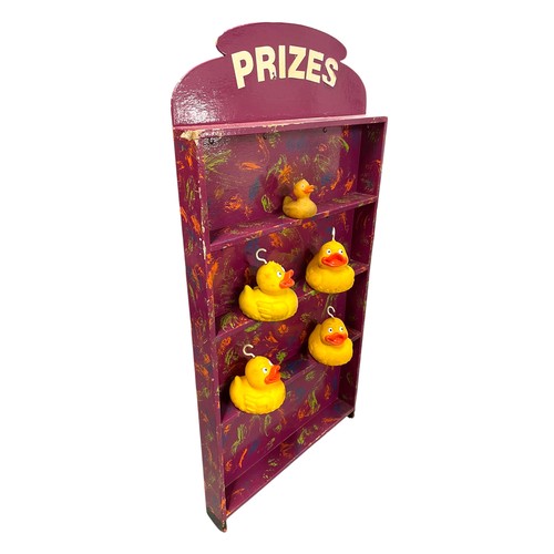 47 - Fairground - A vintage painted wooden hook-a-duck prize shelf, complete with rubber ducks, H 125cm x... 
