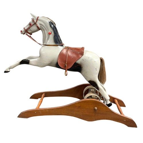 53 - Fairground interest - A Mid 20th Century painted fibreglass and wooden rocking horse, with iron spru... 