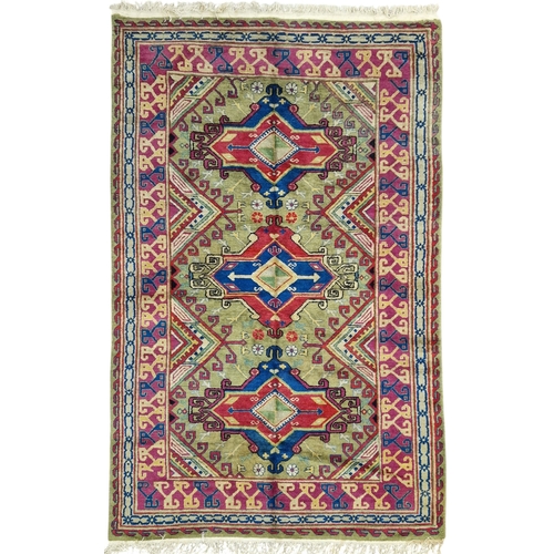Samarkand three medallion rug on a green ground, 240cm x 145cm