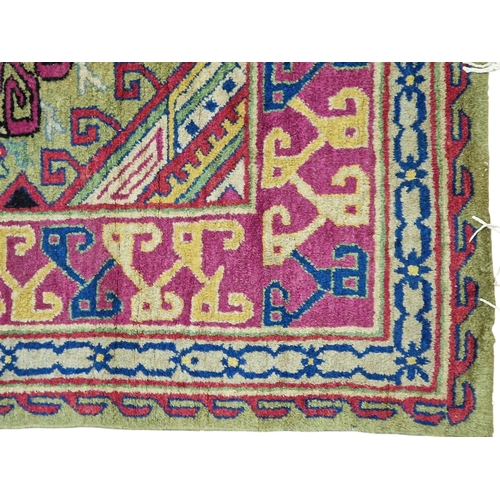 Samarkand three medallion rug on a green ground, 240cm x 145cm