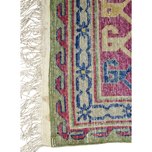Samarkand three medallion rug on a green ground, 240cm x 145cm