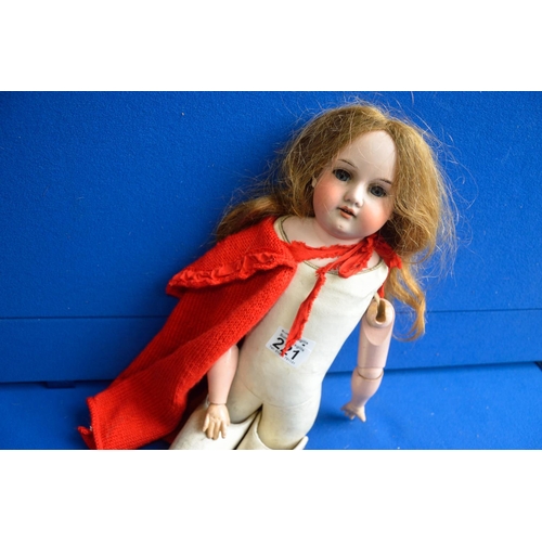 221 - Bisque doll with red cape