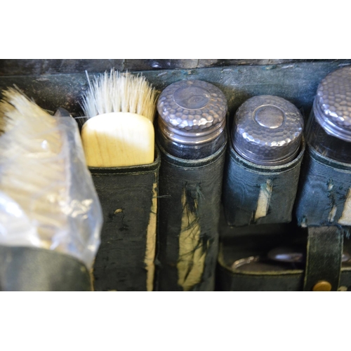 53 - Antique Gentleman's travel/dressing case with halmarked silver bottles and dust jacket.