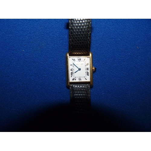 400l - CARTIER 18ct gold wristwatch white dial with roman numerals black leather strap...