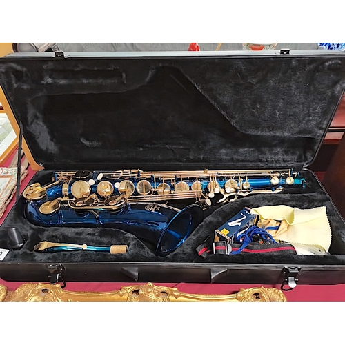 489 - A snazzy coloured blue coloured Saxophone by Stagg in case  slight chips to rear paint work oth... 