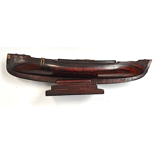 509 - A rosewood 50cm Model of a sailing canoe with letter from National Martime Museum confirming it is p... 