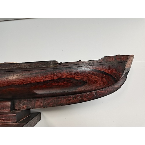 509 - A rosewood 50cm Model of a sailing canoe with letter from National Martime Museum confirming it is p... 