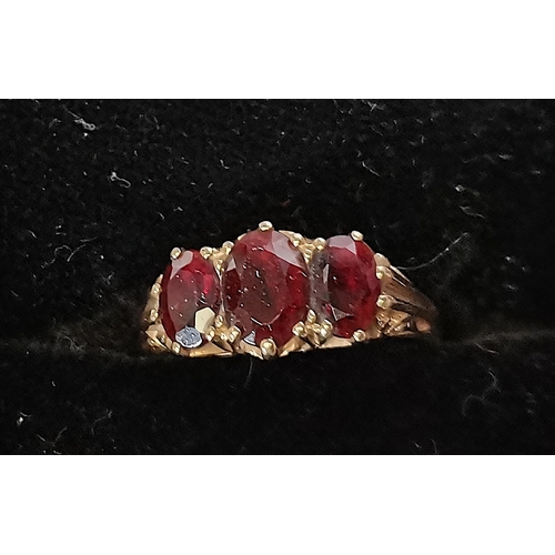 691 - 9ct ornate ring ornate decoration with 3 large red stones size M