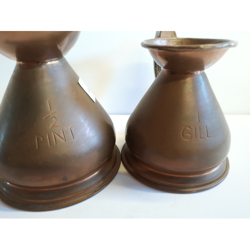 458 - 6 Copper measuring jugs with lead seals