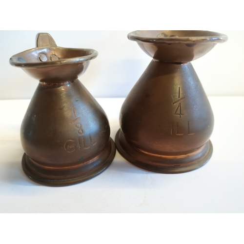 458 - 6 Copper measuring jugs with lead seals