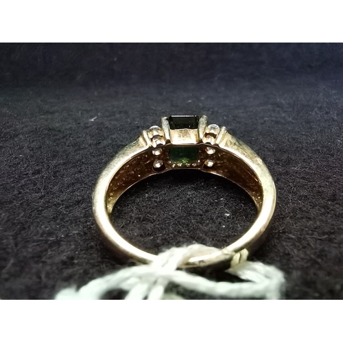 450 - 9ct ring yellow gold size N large green centre stone stepped down with white stone shoulders