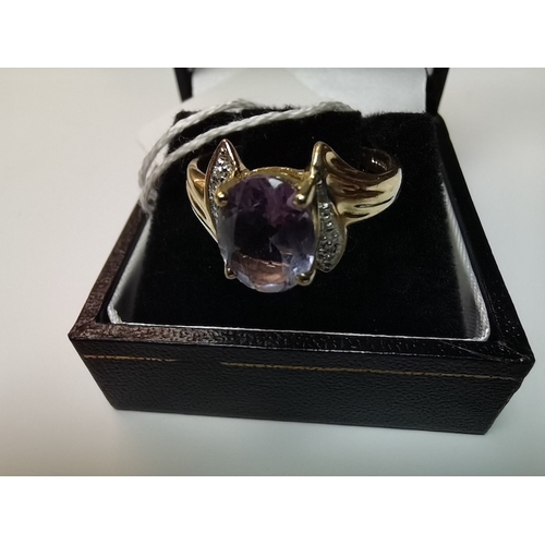 440b - 9ct gold ring size N with large purple stone with white stone shoulders