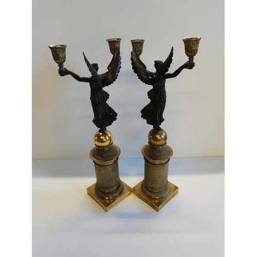 70 - A Pair of French Empire style gilt candle sticks with cherub decoration