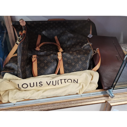 278 - Genuine Louis Vuitton suit carrier and Keepall Duffel brown bag and a Visconti leather documents fol... 