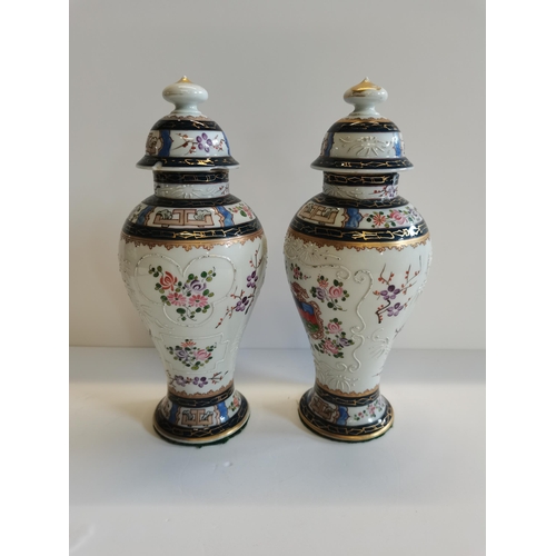 186 - A pair of Chinese covered vases damage to lid and rim