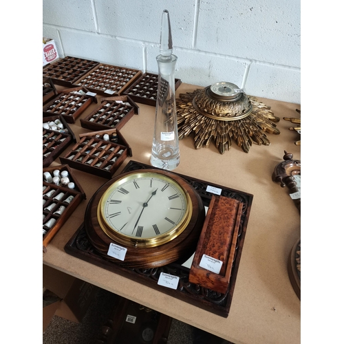 784a - Wooden carved mirror, Walnut type dominoes, Circular wall clock and glass decanter