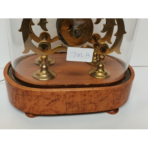 702a - Antique Skeleton Mantle clock on a birds eye maple stand. height 39cm ex condition.