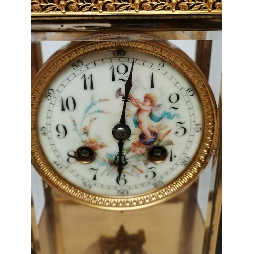 702c - Antique Gilt/brass Mantle Clock with porcelain cherub face decoration ex condition 25cm high x 17cm