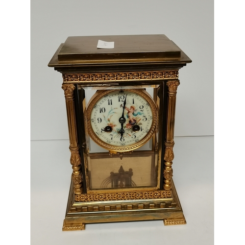 702c - Antique Gilt/brass Mantle Clock with porcelain cherub face decoration ex condition 25cm high x 17cm