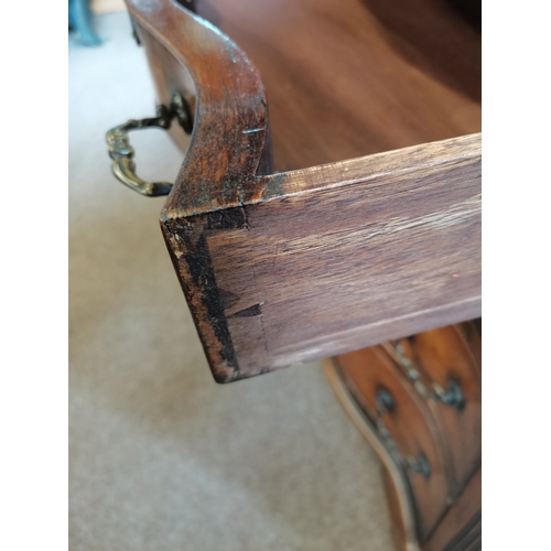 597 - Walnut and mahogany serpentine front bachelors chest having brush slide above four graduated drawers... 