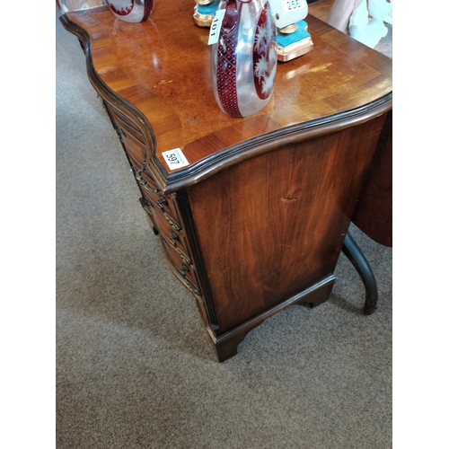 597 - Walnut and mahogany serpentine front bachelors chest having brush slide above four graduated drawers... 