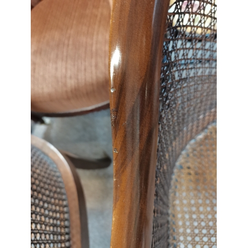 714 - A beautiful pair of mahogany and bergère arm chairs