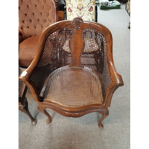 714 - A beautiful pair of mahogany and bergère arm chairs