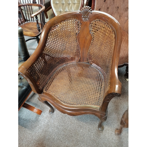 714 - A beautiful pair of mahogany and bergère arm chairs