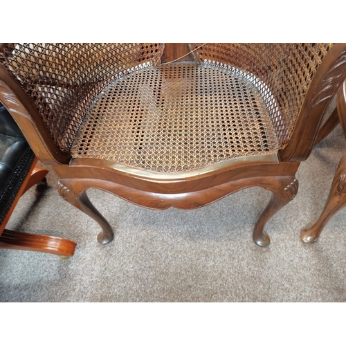 714 - A beautiful pair of mahogany and bergère arm chairs