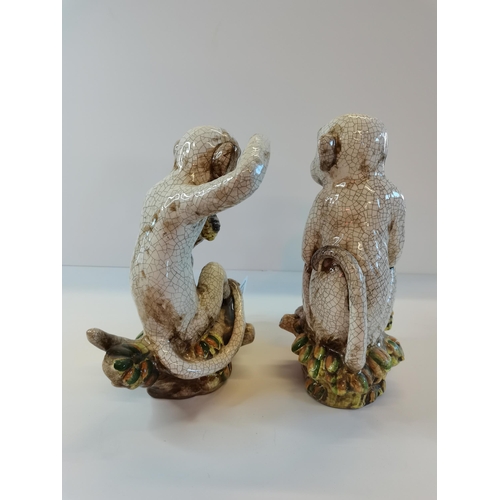 14 - A pair of ceramic monkeys repro.