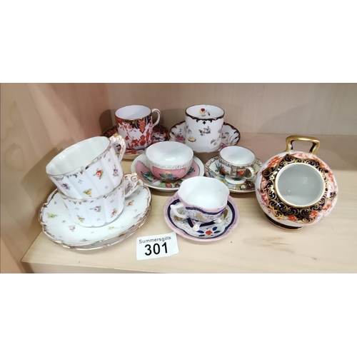 301 - A collection of miniatures cups/saucers incl crown derby