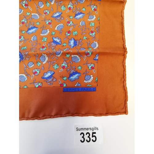 335 - Genuine Hermes 100% silk pocket square. Decorative floral pattern with blue flower heads on bronzed ... 