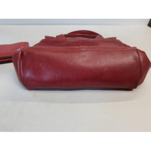 386 - Rust coloured Radley handbag with pink stitching and dust bag .  Matching purse.  Good condition but... 