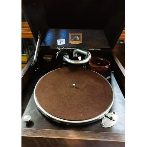 87 - Antique Oak Gramophone HMV model 106 with a selection of 78rpm records